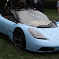 Gordon Murray Automotive T.50 bleu pâle, vue trois-quarts avant | Prova MO / Wikimedia Commons, CC BY-SA 4.0 Gordon Murray Automotive T.50 bleu pâle exposé sur la pelouse d'un concours
